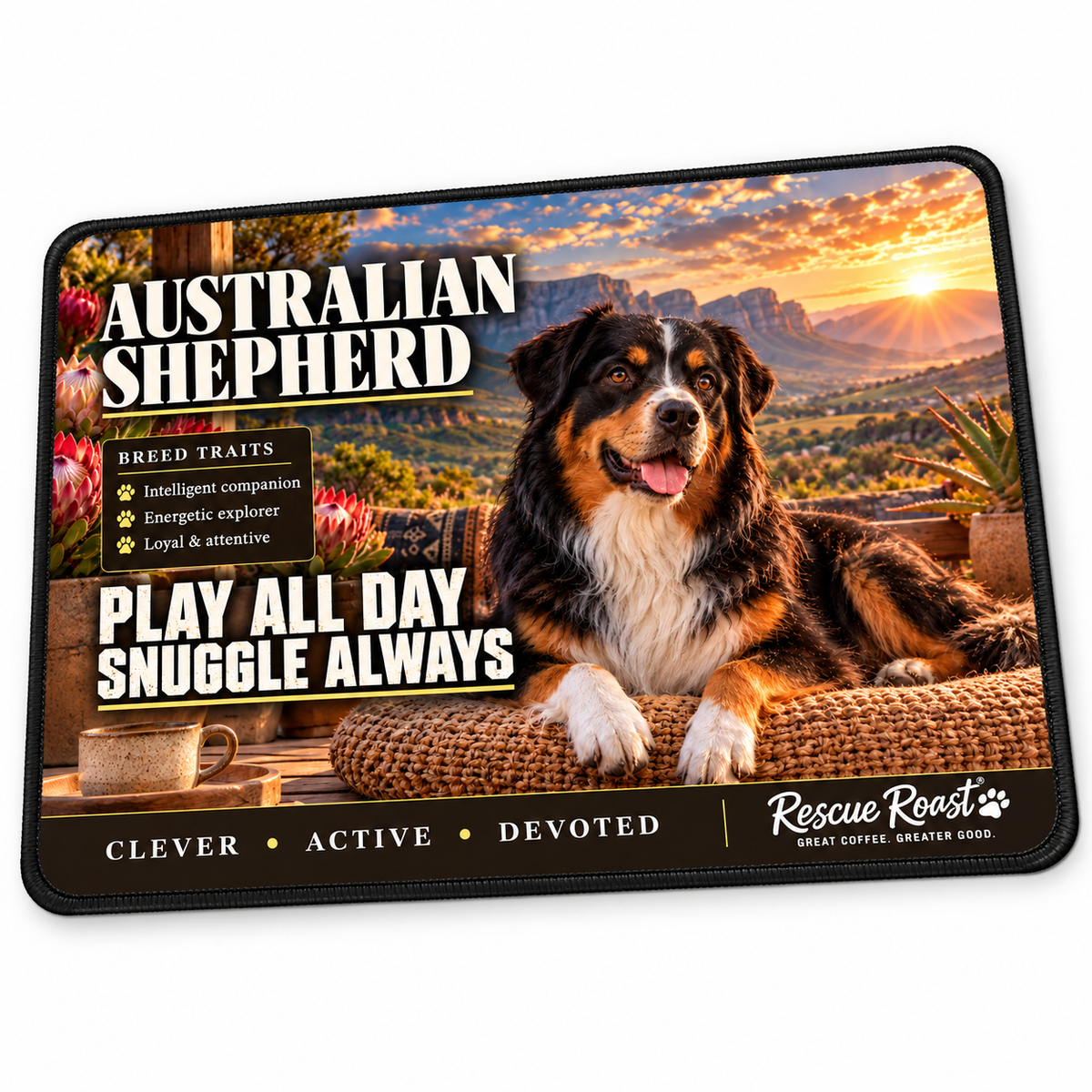Rescue Roast® Australian Shepherd mousepad: Black tricolour Australian Shepherd relaxing beside coffee and proteas, with the words “Play All Day, Snuggle Always”