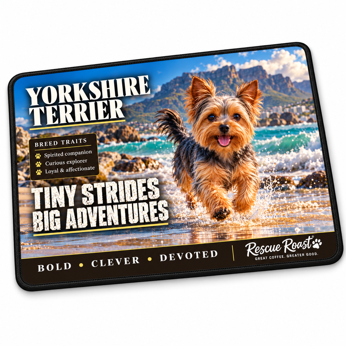 Rescue Roast Yorkshire Terrier mousepad: A happy Yorkshire Terrier runs through the sparkling shallows of a rocky beach beneath a coastal mountain. Printed slogan: Tiny Strides, Big Adventures.