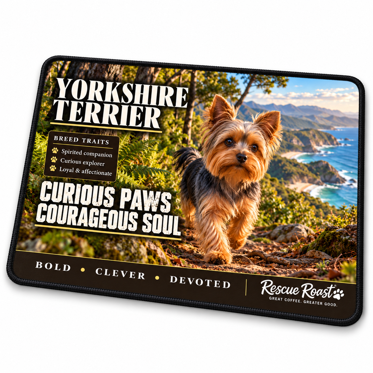 Rescue Roast Yorkshire Terrier mousepad: A Yorkshire Terrier explores a fern-lined forest trail overlooking a rugged, sunlit coastline. Printed slogan: Curious Paws, Courageous Soul.